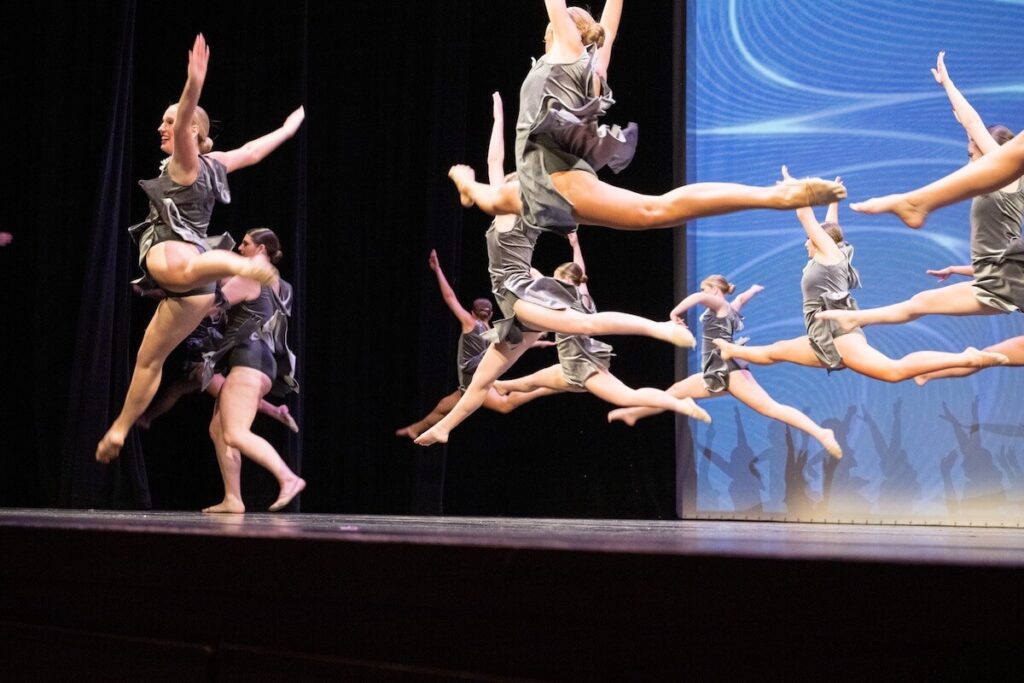 Dancers leaping on stage