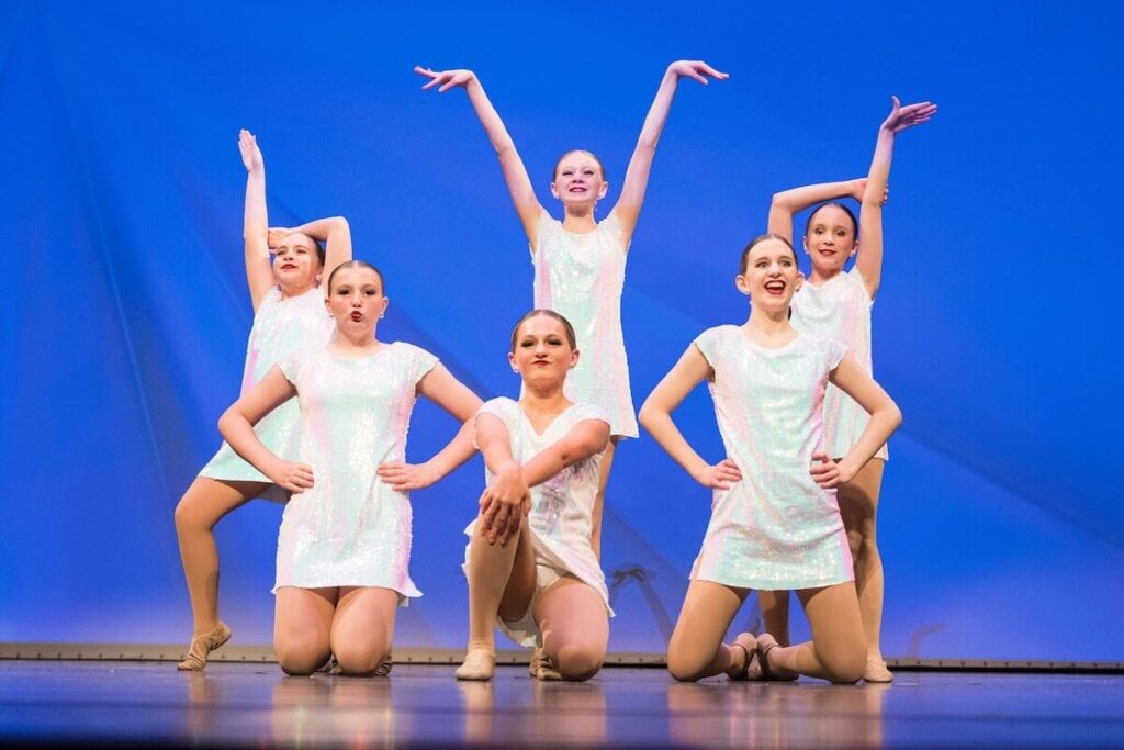 dancers in dance recital in white costume