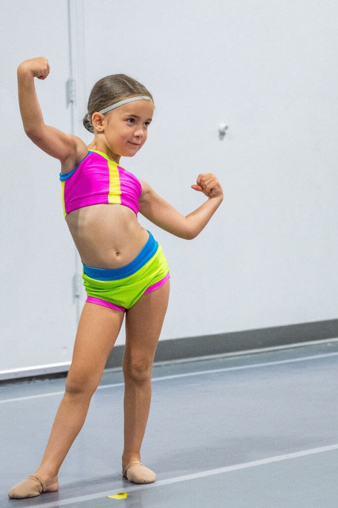 Dancer in neon inside dance studio